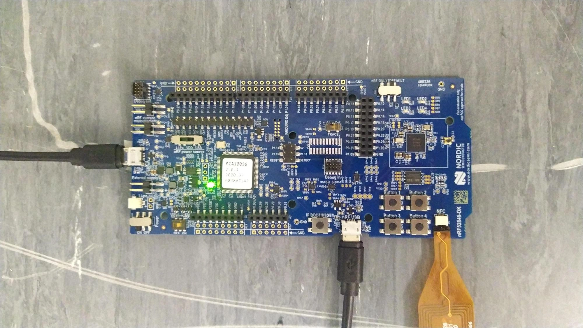 An nRF52840 DK with two USB cables connected to it