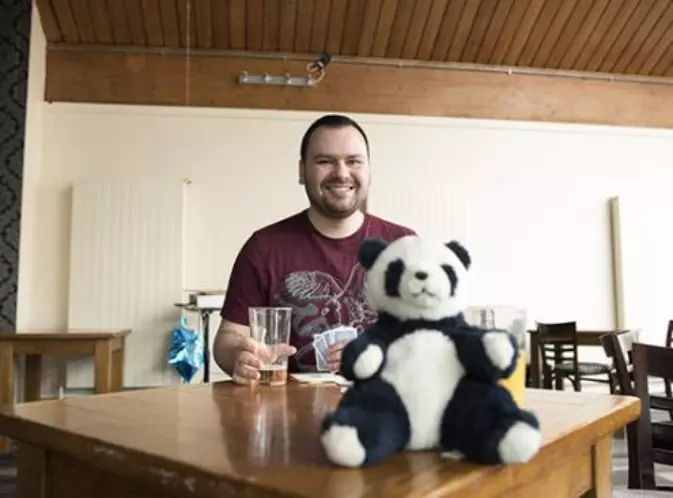 Matthew with a pint in hand and a toy panda in the foreground