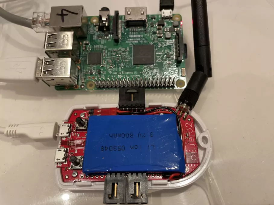 A Raspberry Pi next to a Zolertia RE-Mote with both circuit boards exposed